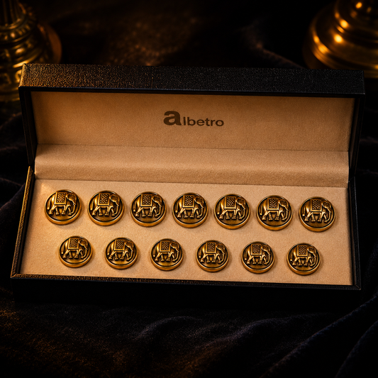 Set of gold elephant buttons in an open box with 'albetro' branding on a dark background.