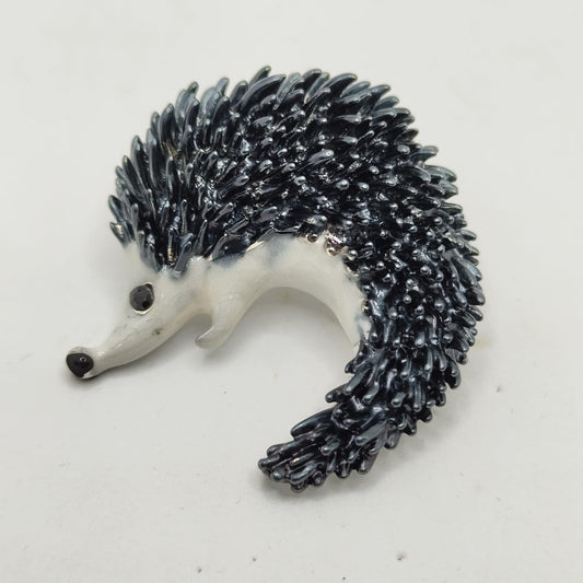 Hedgehog figurine with black spines on a white background