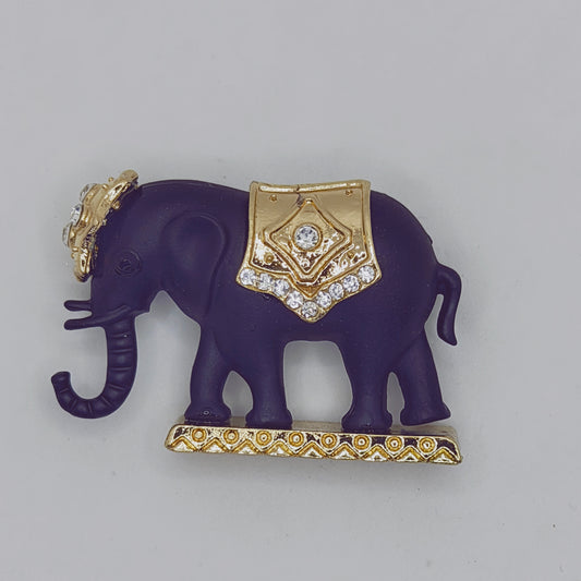 A vintage Matt Black Elephant Brooch with gold accents and sparkling rhinestones on the elephant's back.