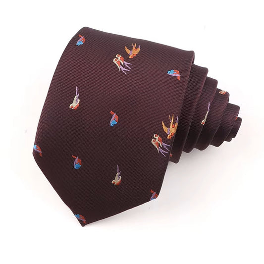 A folded burgundy tie with an embroidered bird pattern on a white background.