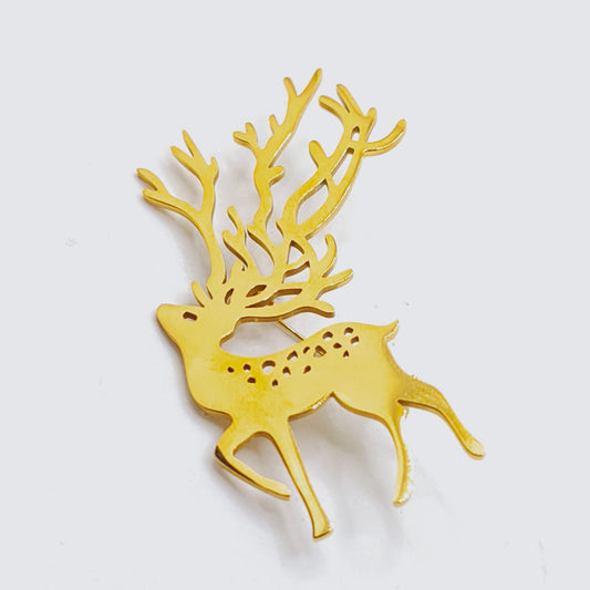 Gold deer-shaped ornament on a white background