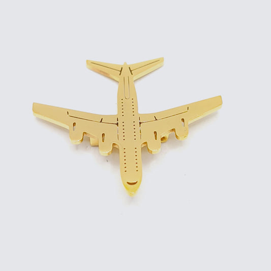 Gold airplane-shaped object on a white background