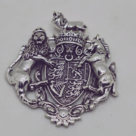 Silver emblem with lions and a shield on a gray background
