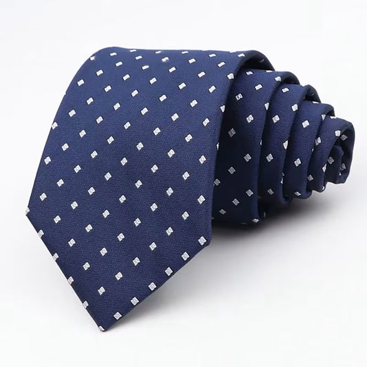 Navy blue tie with white polka dots on a white background