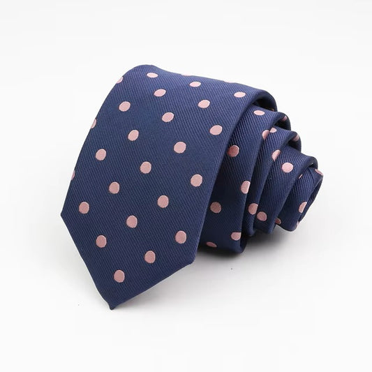 Navy blue tie with pink polka dots on a white background