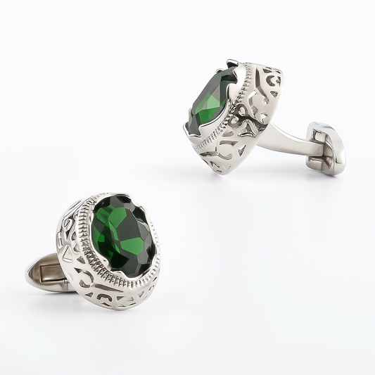 Silver cufflinks with green gemstones on a white background