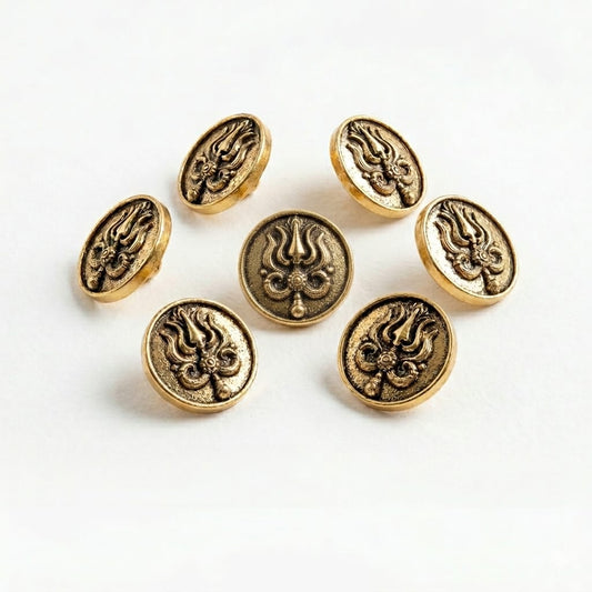 Gold buttons with intricate designs on a white background