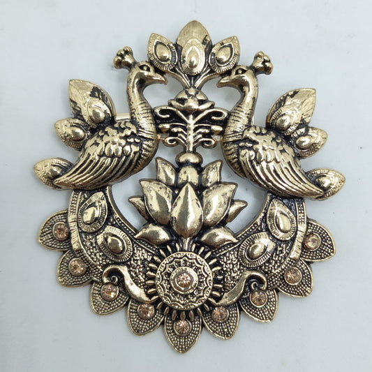 Decorative brass peacock design on a light gray background