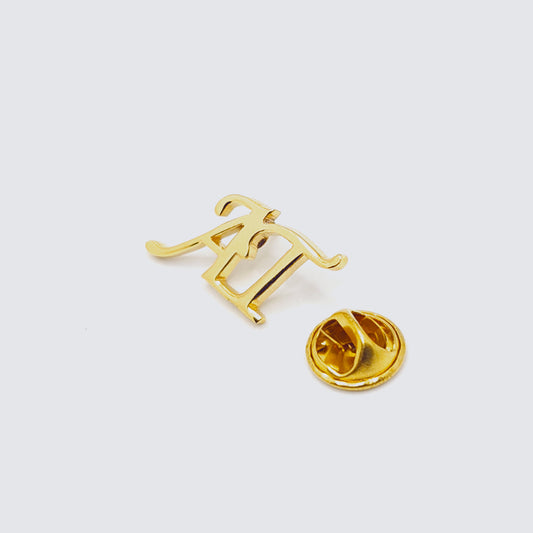 Gold tie clip with a unique design on a white background