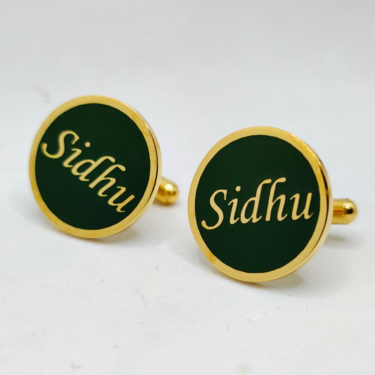 Cufflinks with 'Sidhu' engraving on a green background