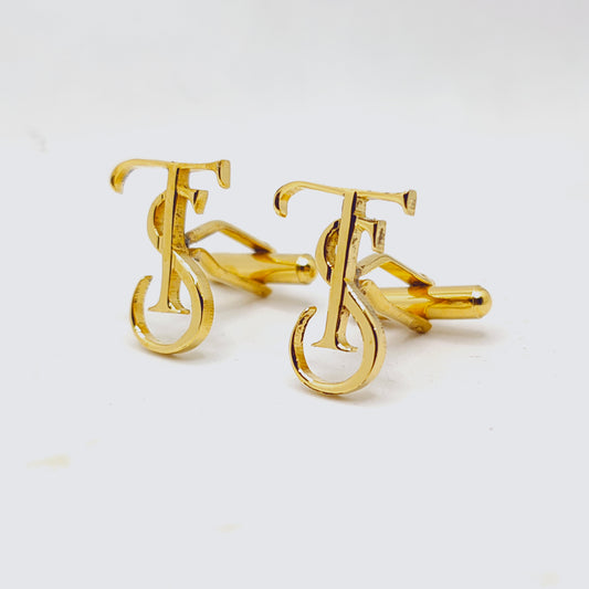 Gold cufflinks with a unique design on a white background