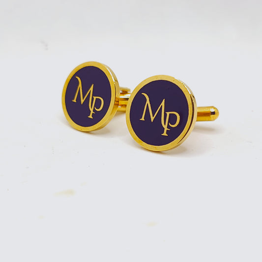 Gold cufflinks with purple circular design and 'MP' initials on a white background