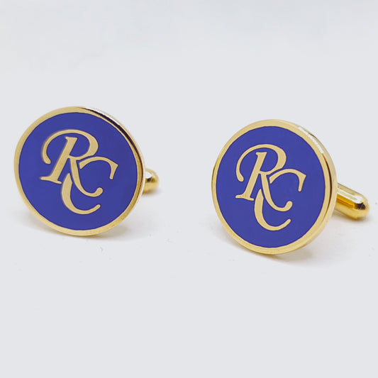 Pair of cufflinks with 'RC' logo on a blue background