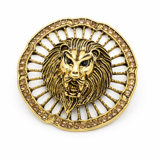 Gold lion head emblem with gemstones on a white background