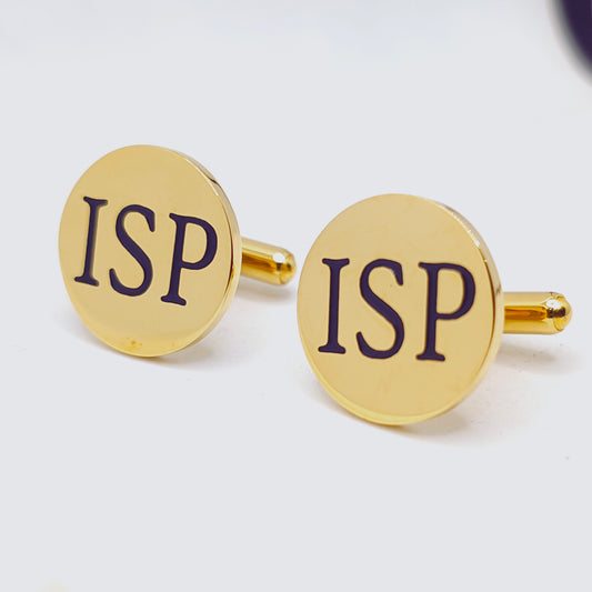 Gold cufflinks with 'ISP' engraving on a white background