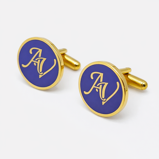 Gold and blue cufflinks with 'AV' logo on a white background