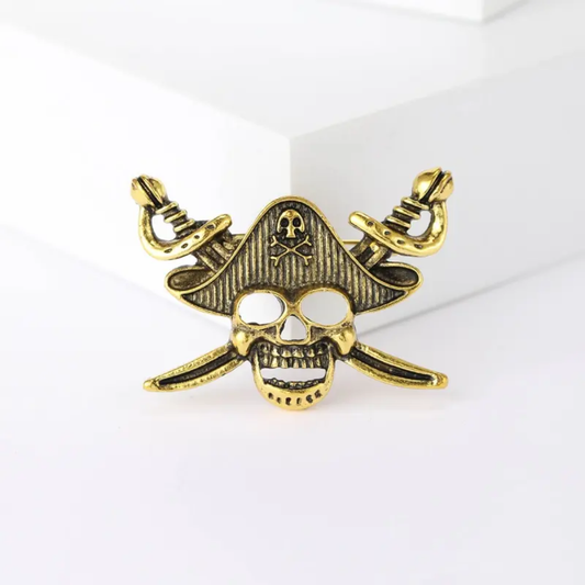 Gold pirate-themed pendant with skull and crossed swords on a white background