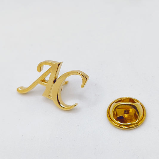 Gold-colored jewelry piece on a white background