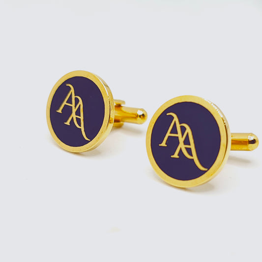 Gold cufflinks with a blue circular design on a white background