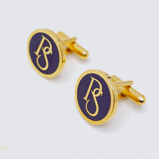 Gold cufflinks with a blue oval design featuring a monogram on a white background