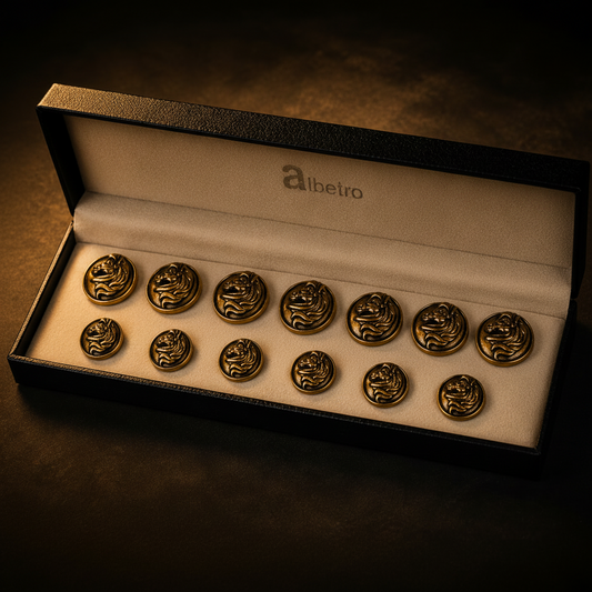 Set of gold buttons in a 'Albetro' box on a dark background
