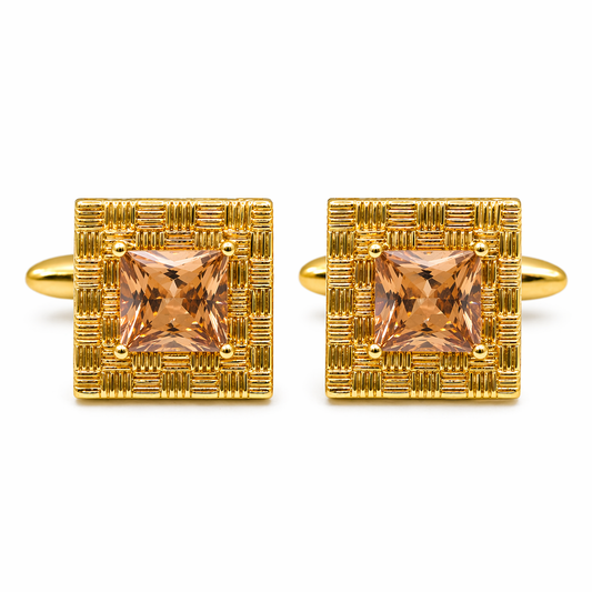 Gold cufflinks with square gemstones on a white background