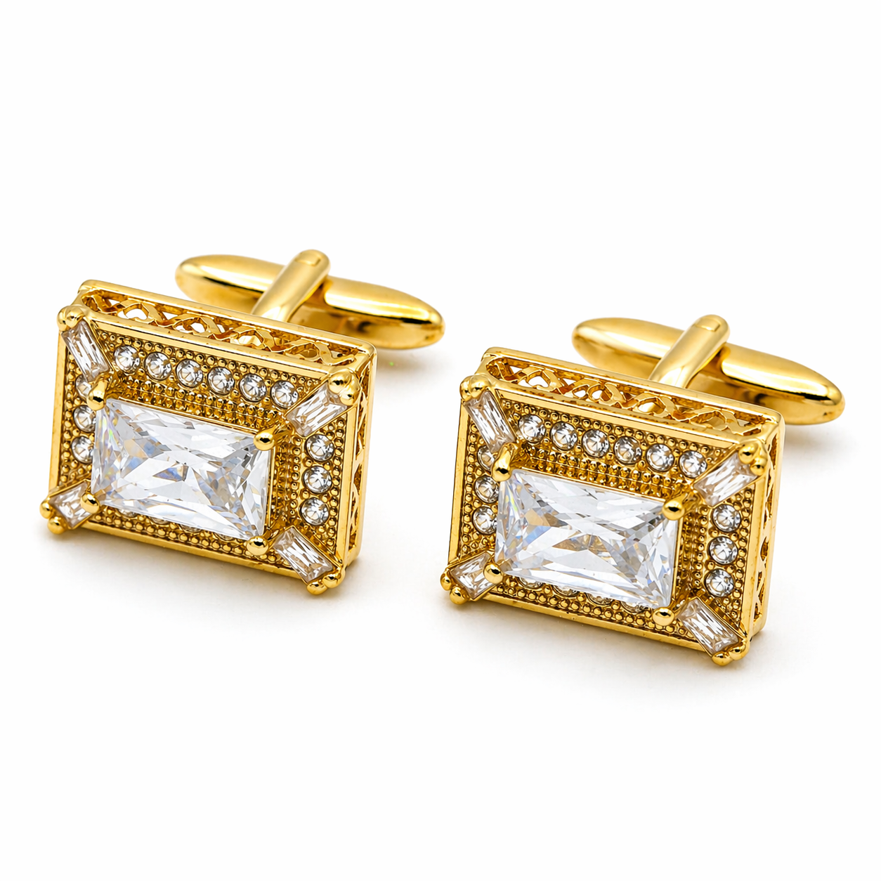 Gold cufflinks with clear gemstones on a white background