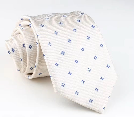 Folded white tie with blue pattern on a light gray background