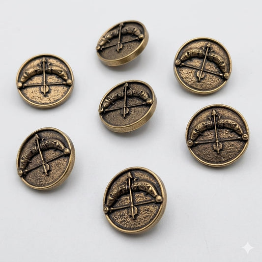Set of bronze buttons with intricate designs on a white background