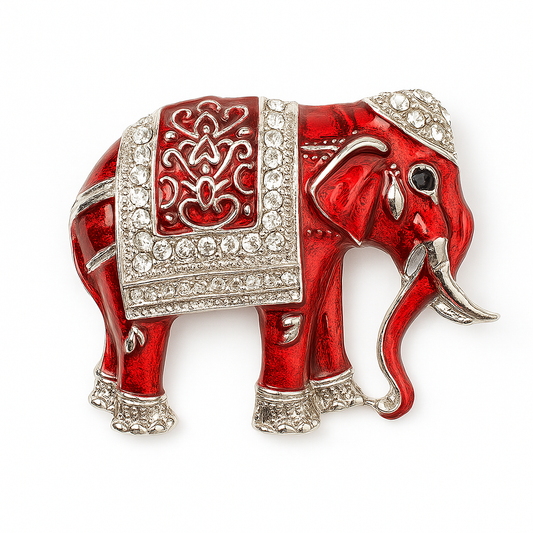 Red elephant brooch with silver detailing on a white background