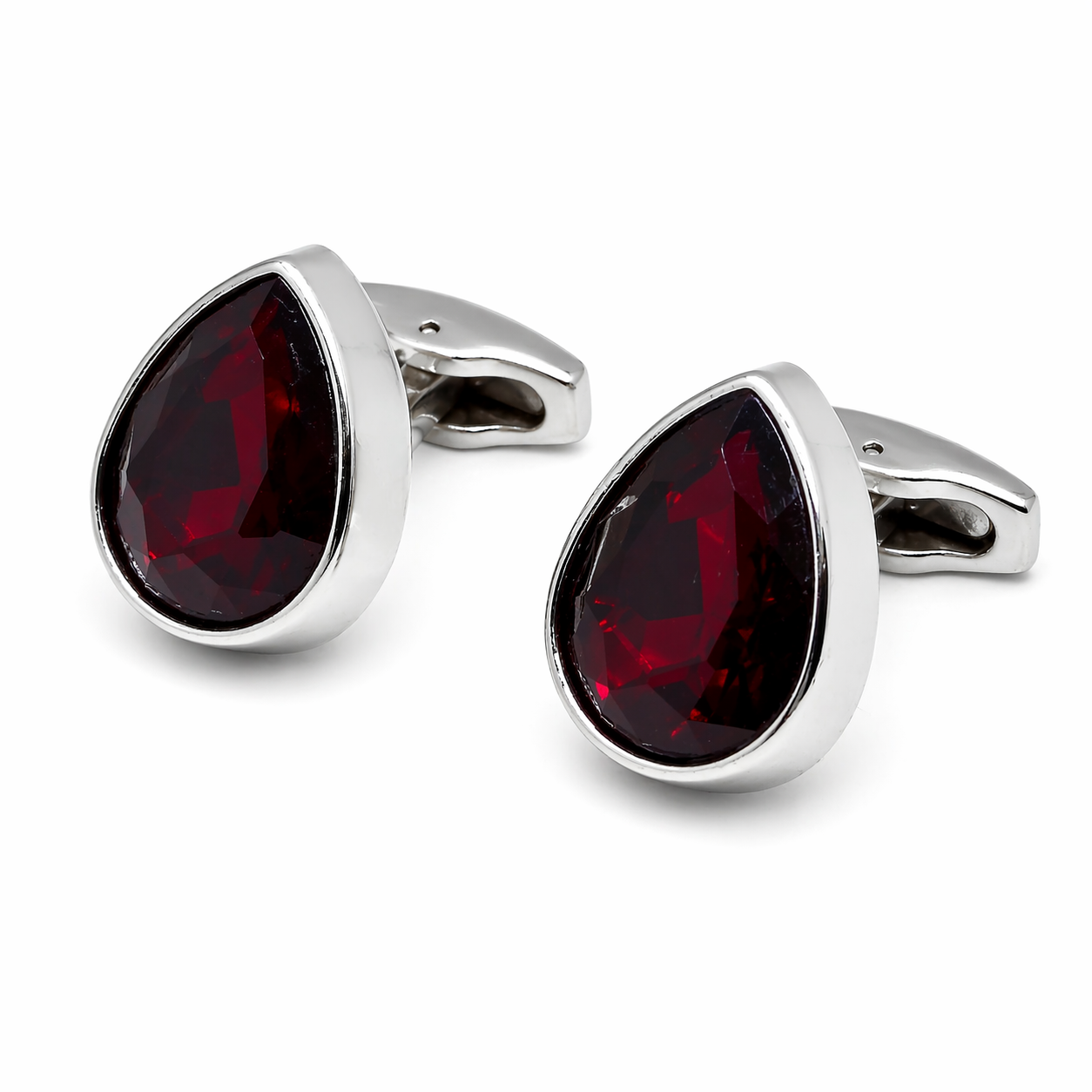 Silver cufflinks with red gemstones on a white background