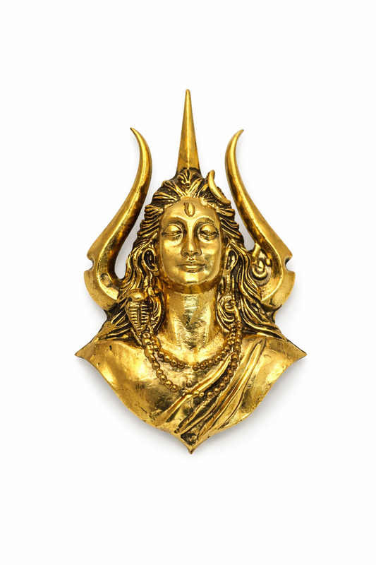Gold-colored decorative wall piece with a face and horns on a white background
