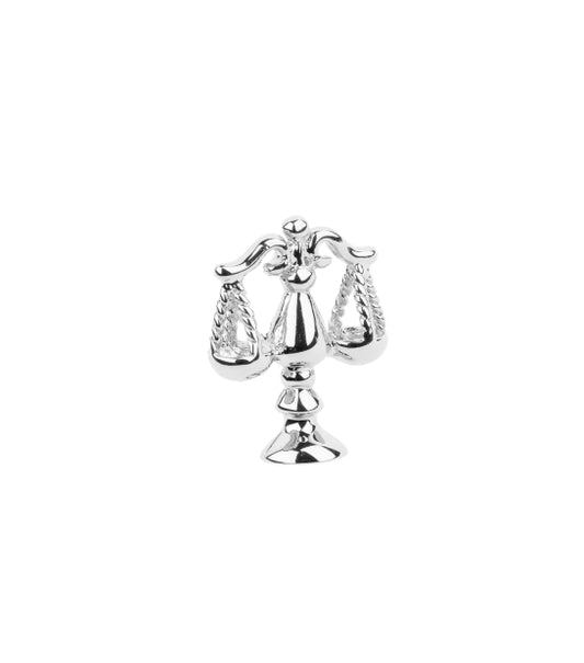 Silver Libra zodiac charm on a white background